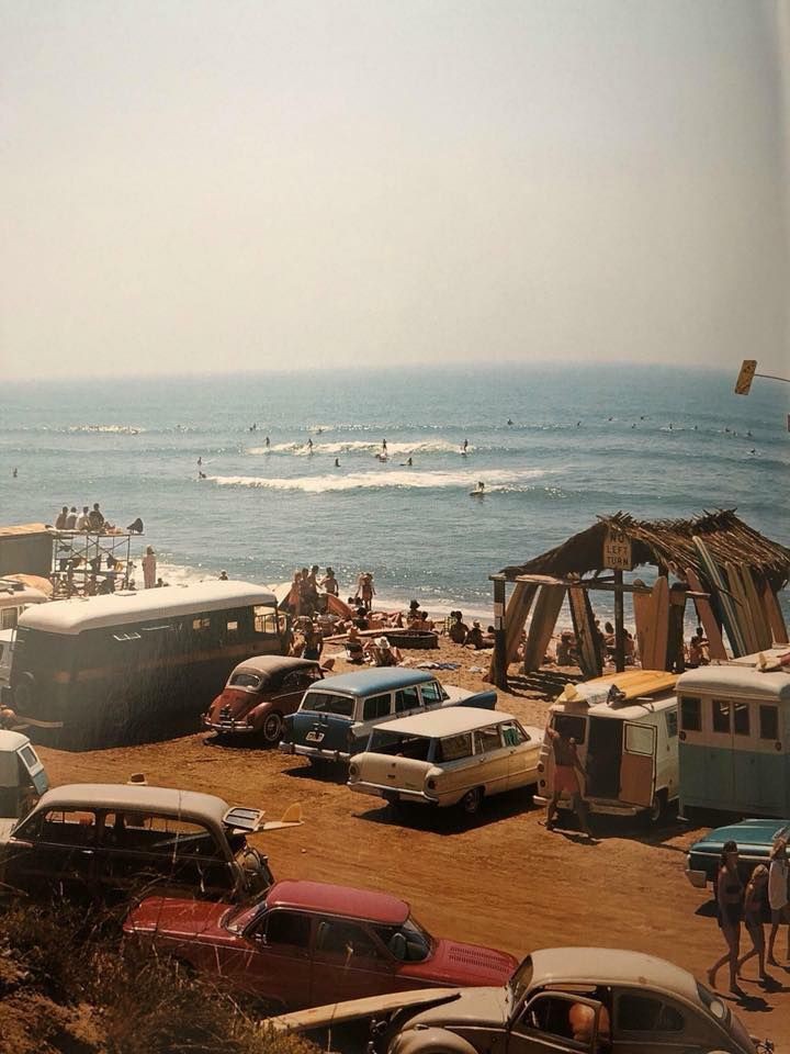 Vintage cars and camper vans parked near a beach