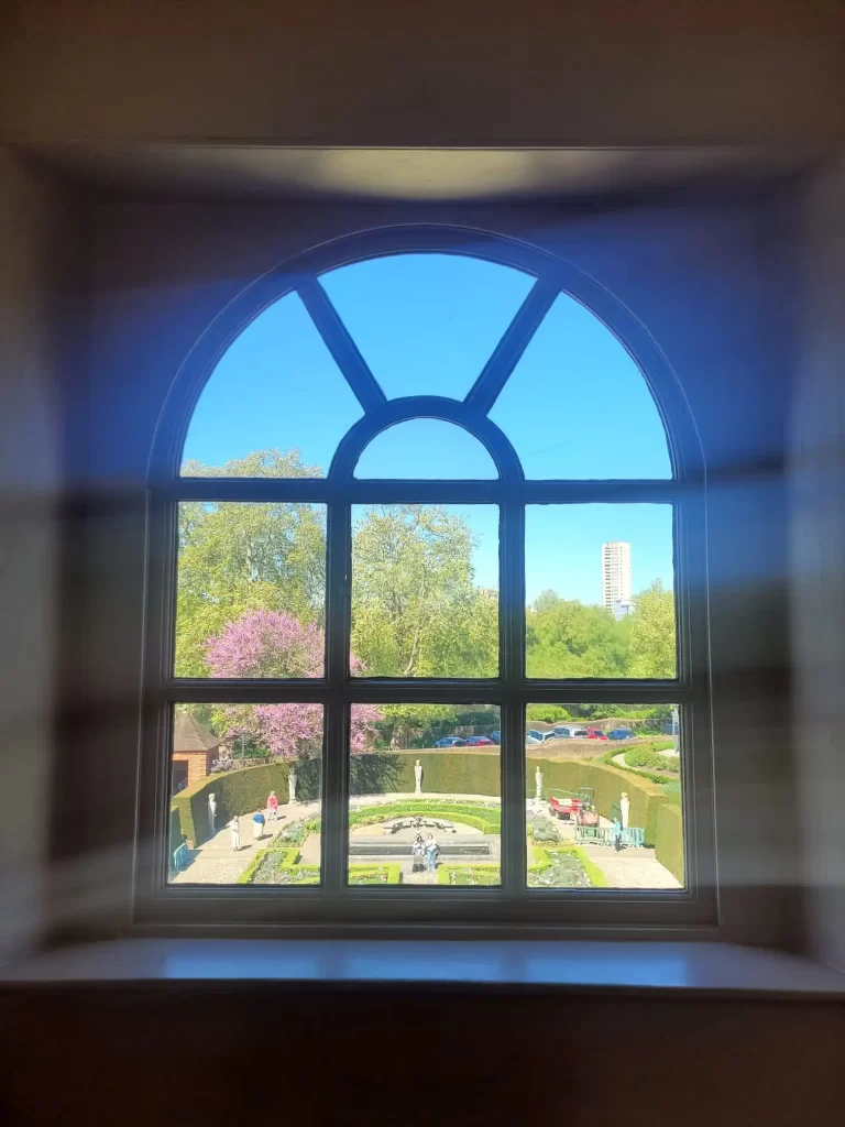 A view of Queen Charlotte's garden through a window in Kew Palace